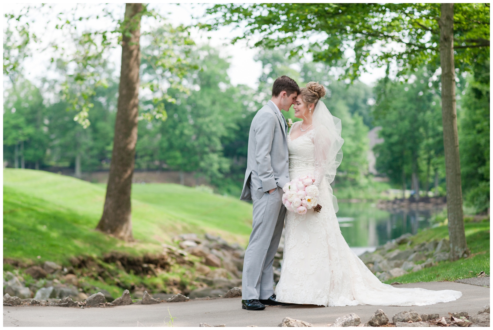 bride and groom lovingly embrace each other on a bridge at the wedgewood golf and country club in powell ohio 
