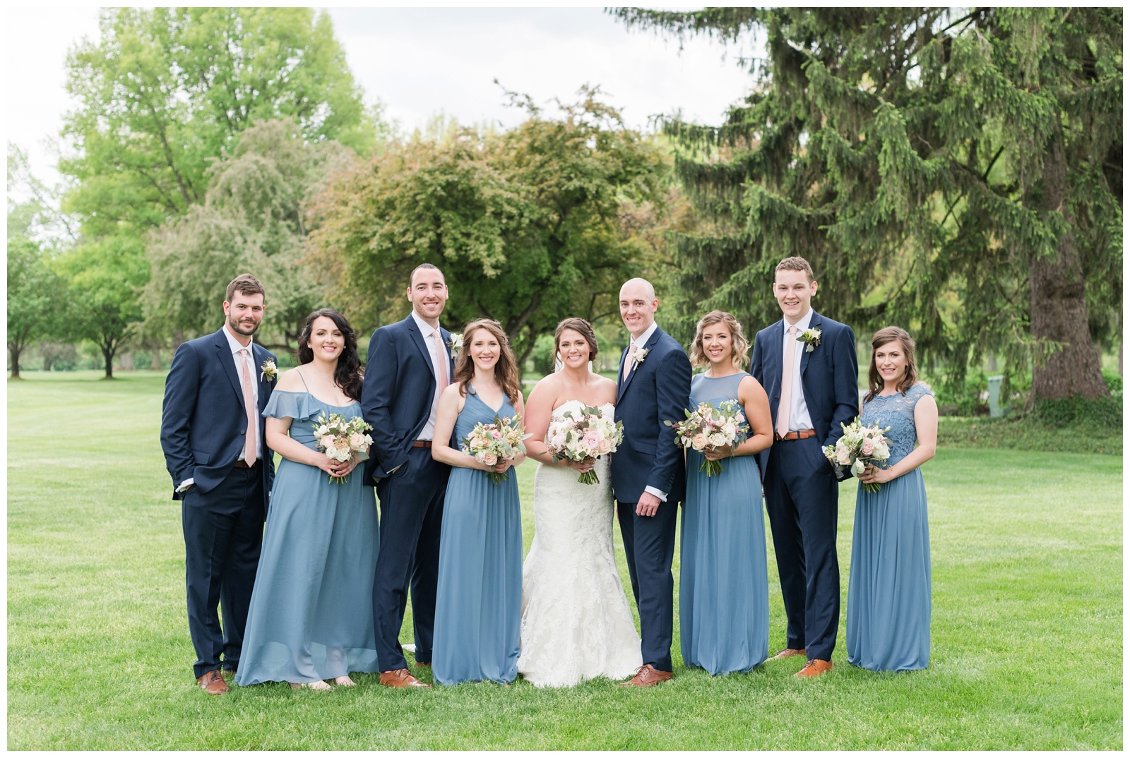 elegant Brookside Golf and Country Club wedding party in blue dresses and navy suits