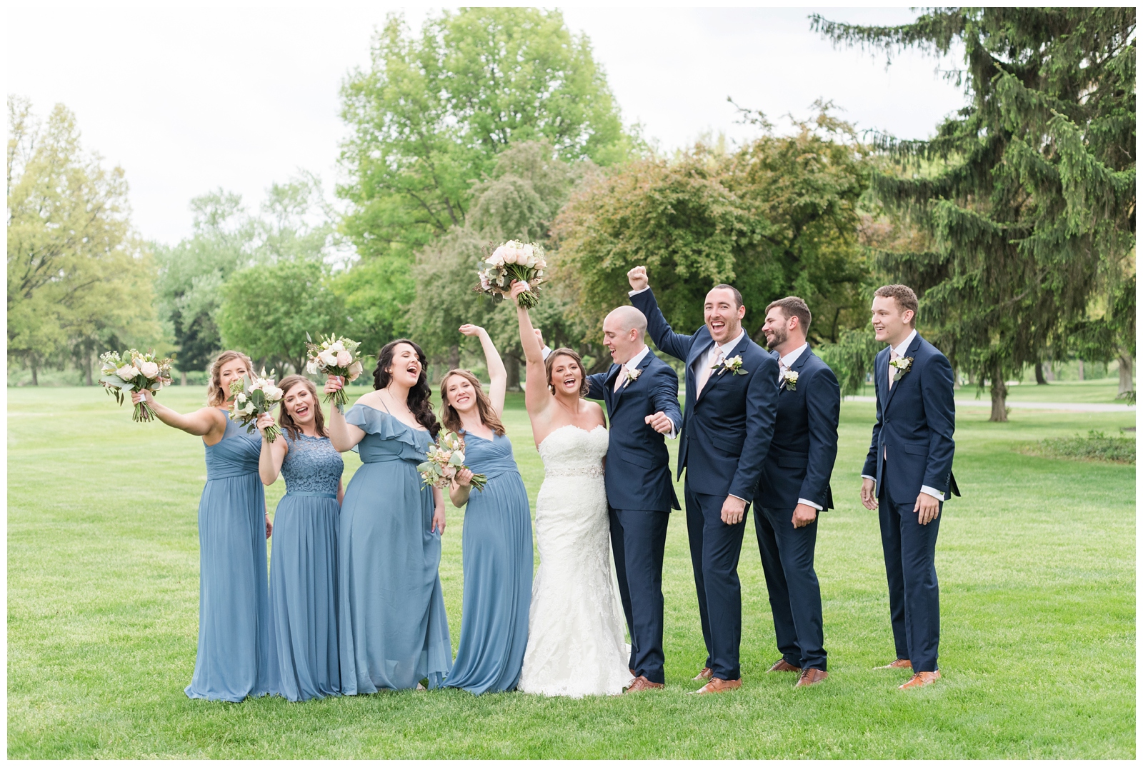 bridesmaids and groomsmen cheer for newlyweds on Ohio wedding day