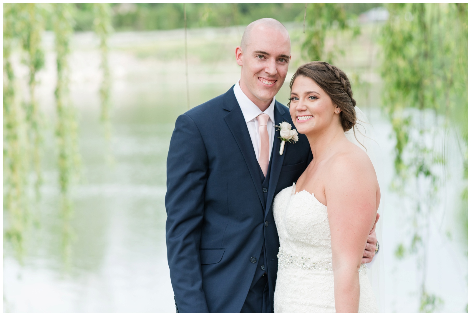 bride and groom smile at Ohio wedding photographer Piper's Photography during portraits under willow tree
