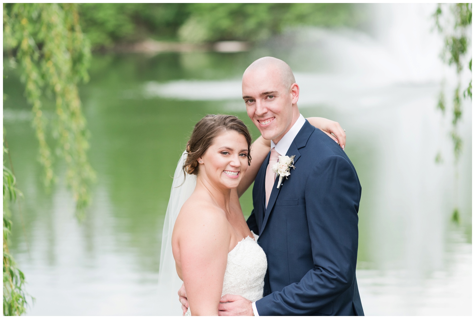 bride and groom stand facing each other with bride's arm around groom's shoulder during Ohio wedding portraits
