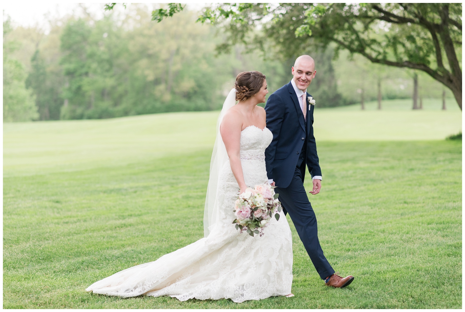 bride and groom hold hands walking across green at Brookside Golf and Country Club