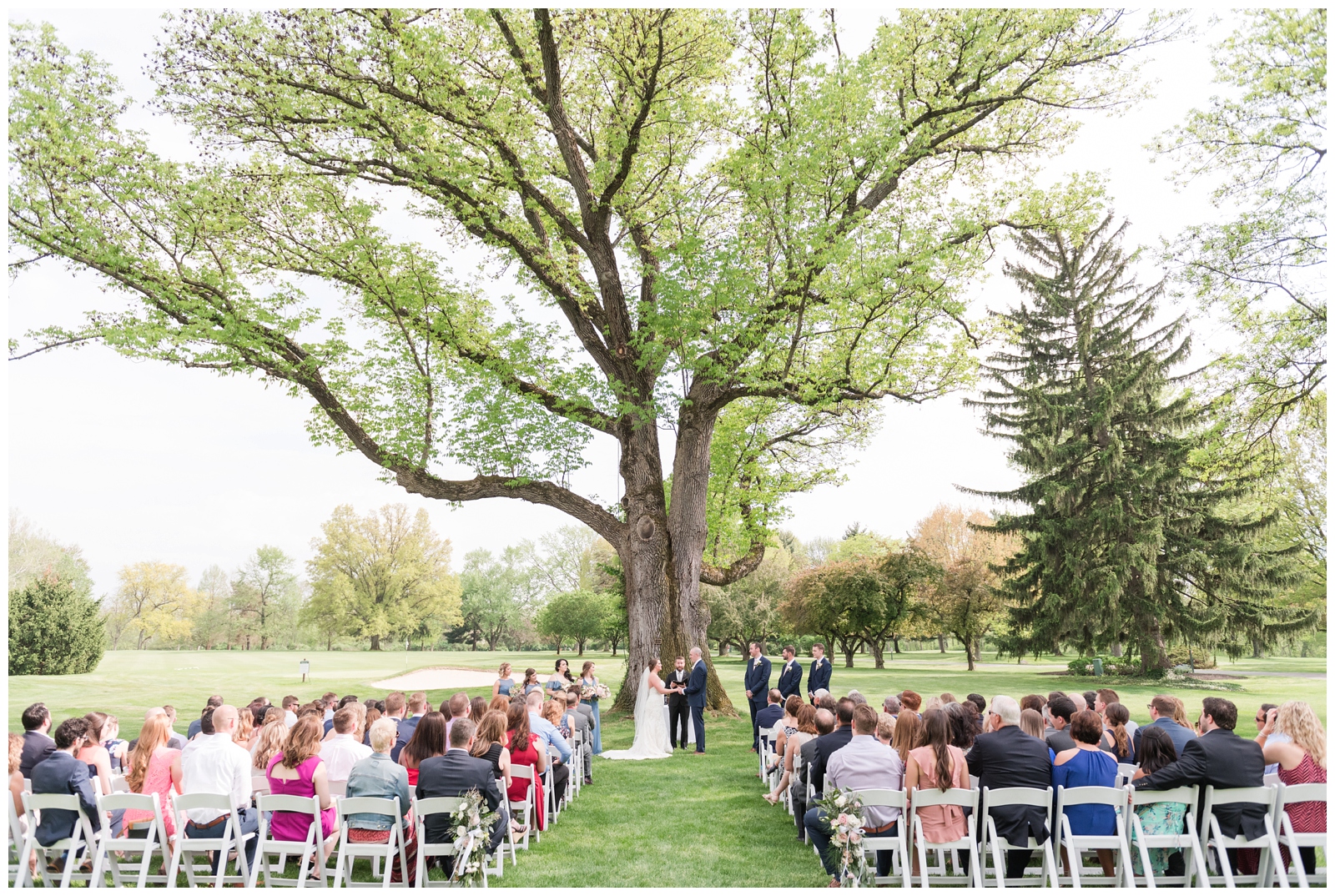 wide shot of wedding ceremony in summer at Brookside Golf and Country Club