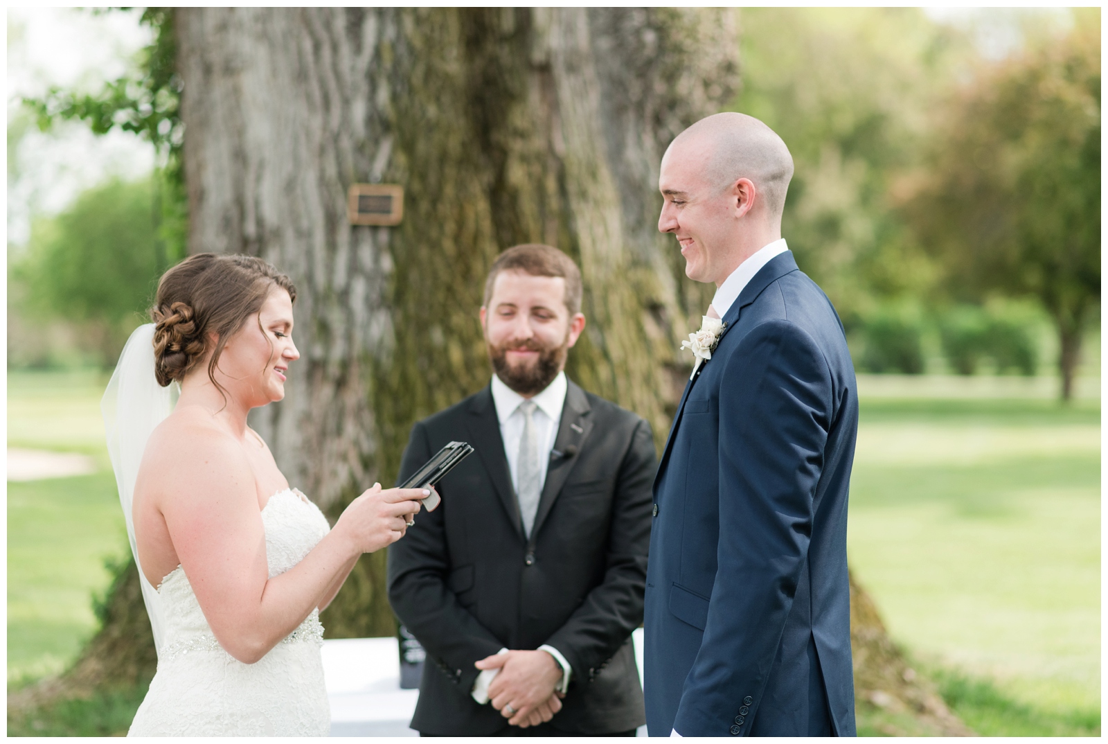 bride reads groom her vows during summer wedding ceremony in Ohio