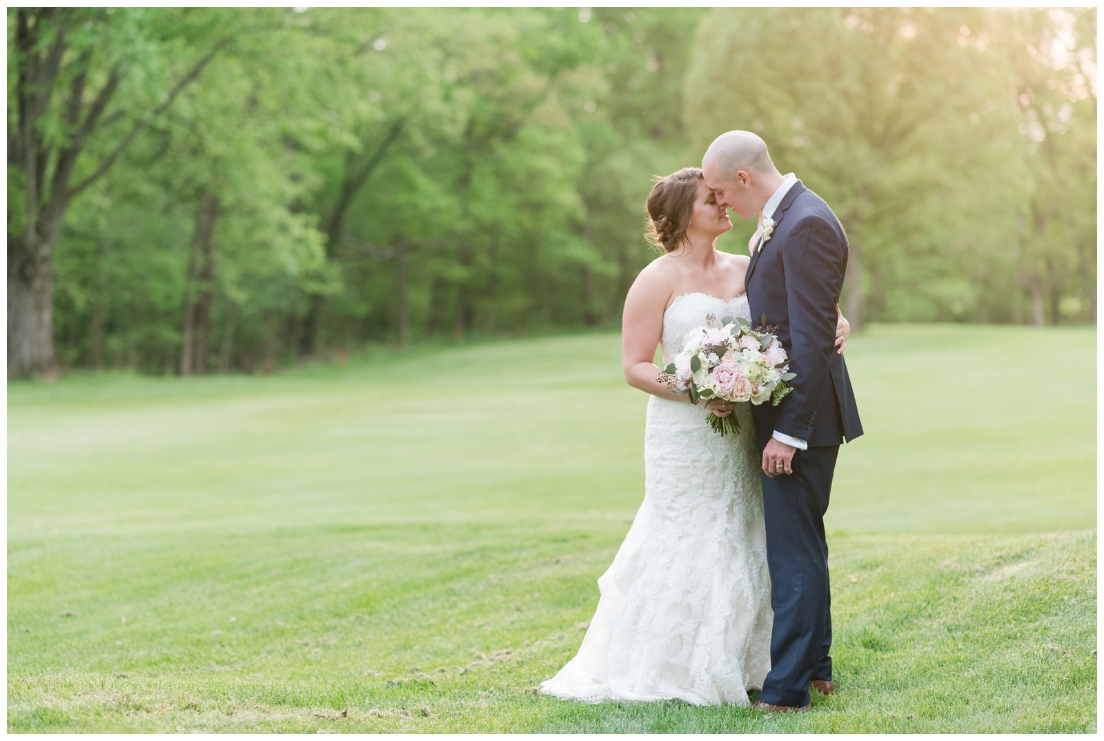bride and groom hug for wedding photo on green at Brookside Golf and Country Club in Columbus OH