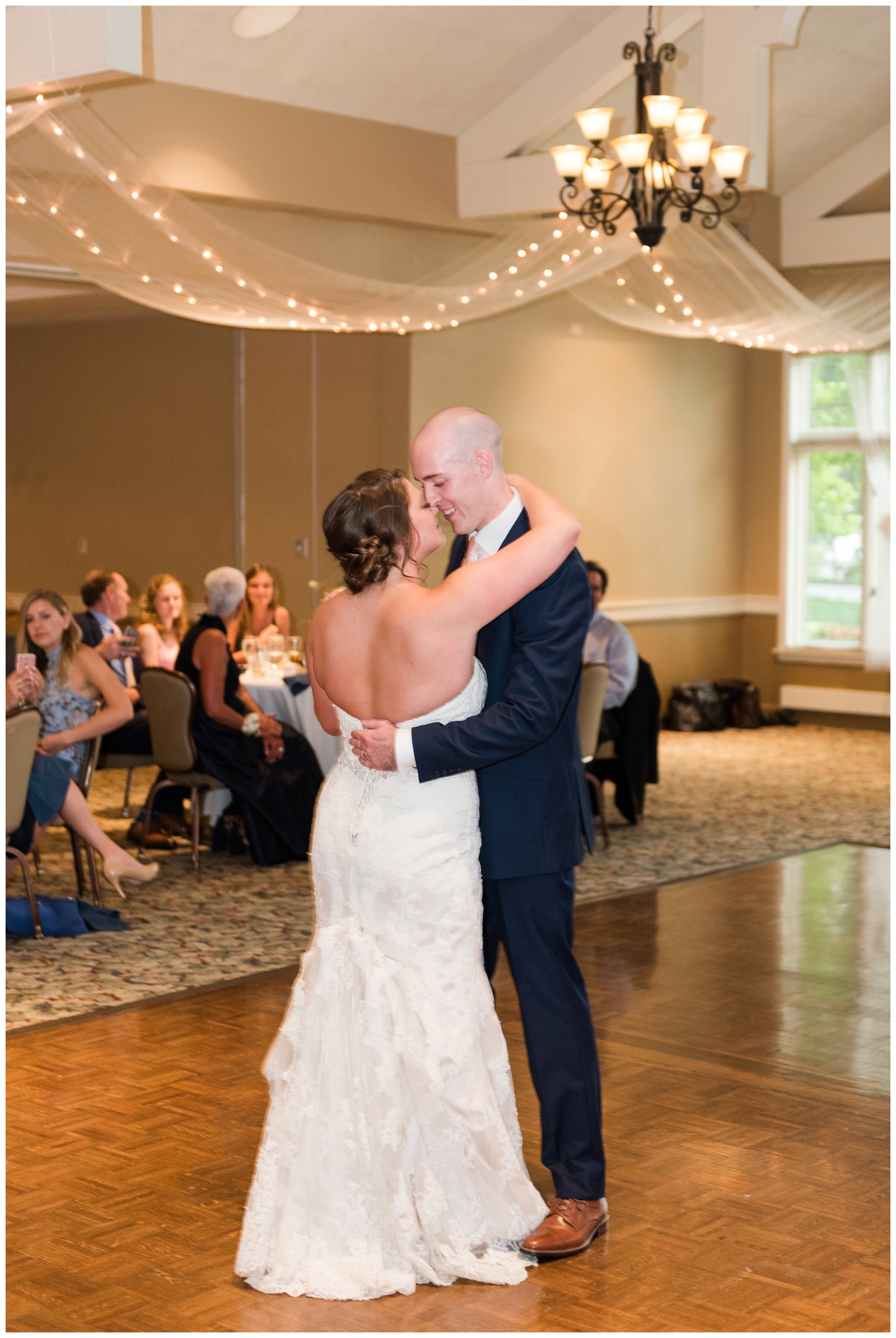groom nuzzles nose with bride during first dance at wedding reception in Ohio