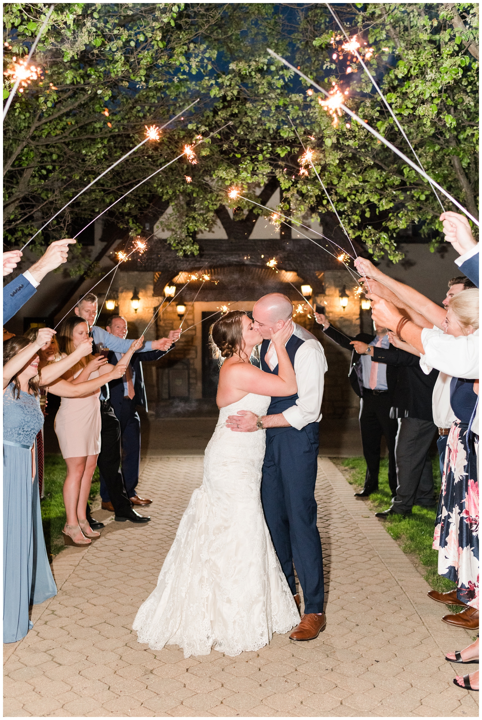 bride and groom kiss during sparkler exit from Columbus OH wedding day