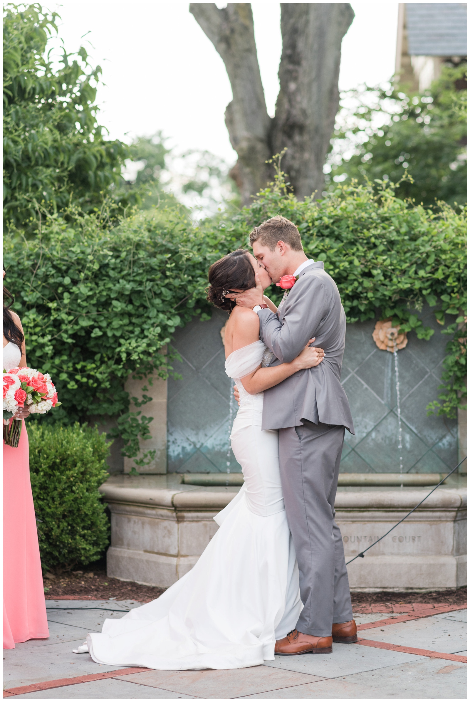 groom and bride share first kiss as husband and wife at The Wells Barn