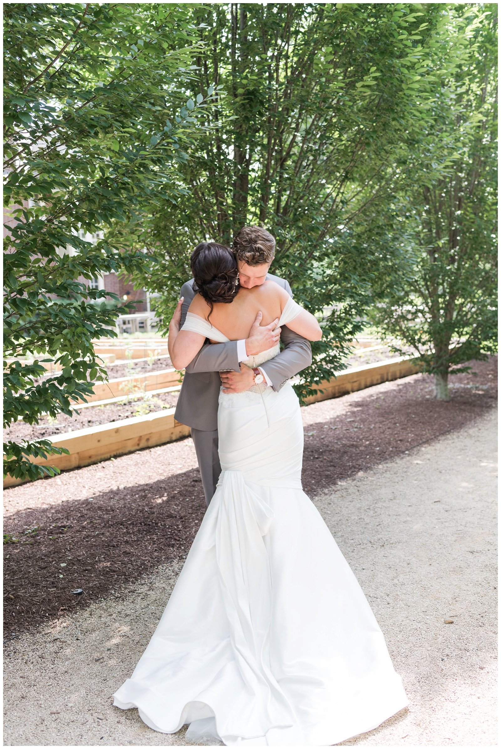 bride and groom embrace during first look at The Wells Barn 