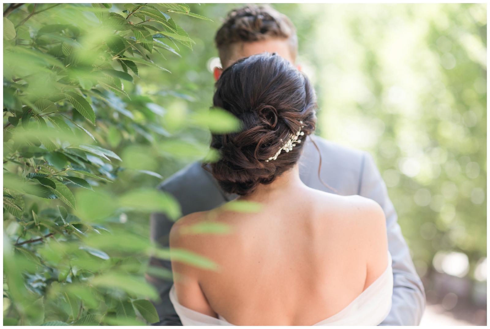 bride looks at groom during portraits showing off her updo and jeweled hairpiece