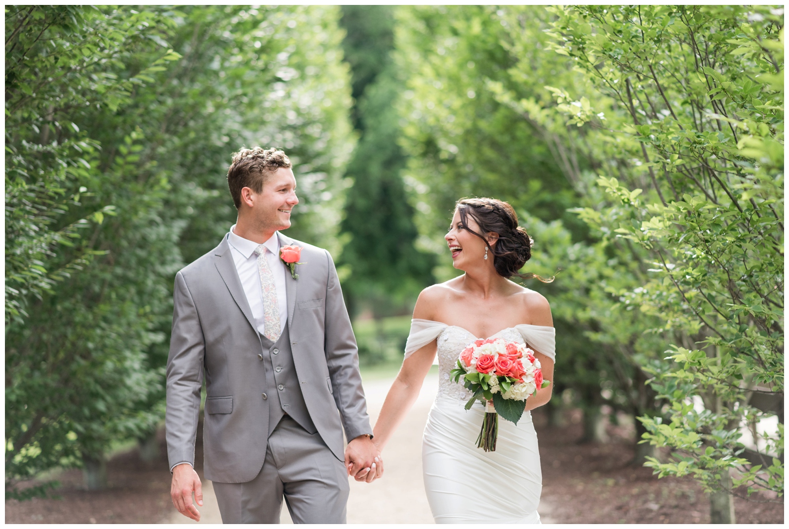 bride and groom hold hands while walking and laughing during wedding portraits in Ohio