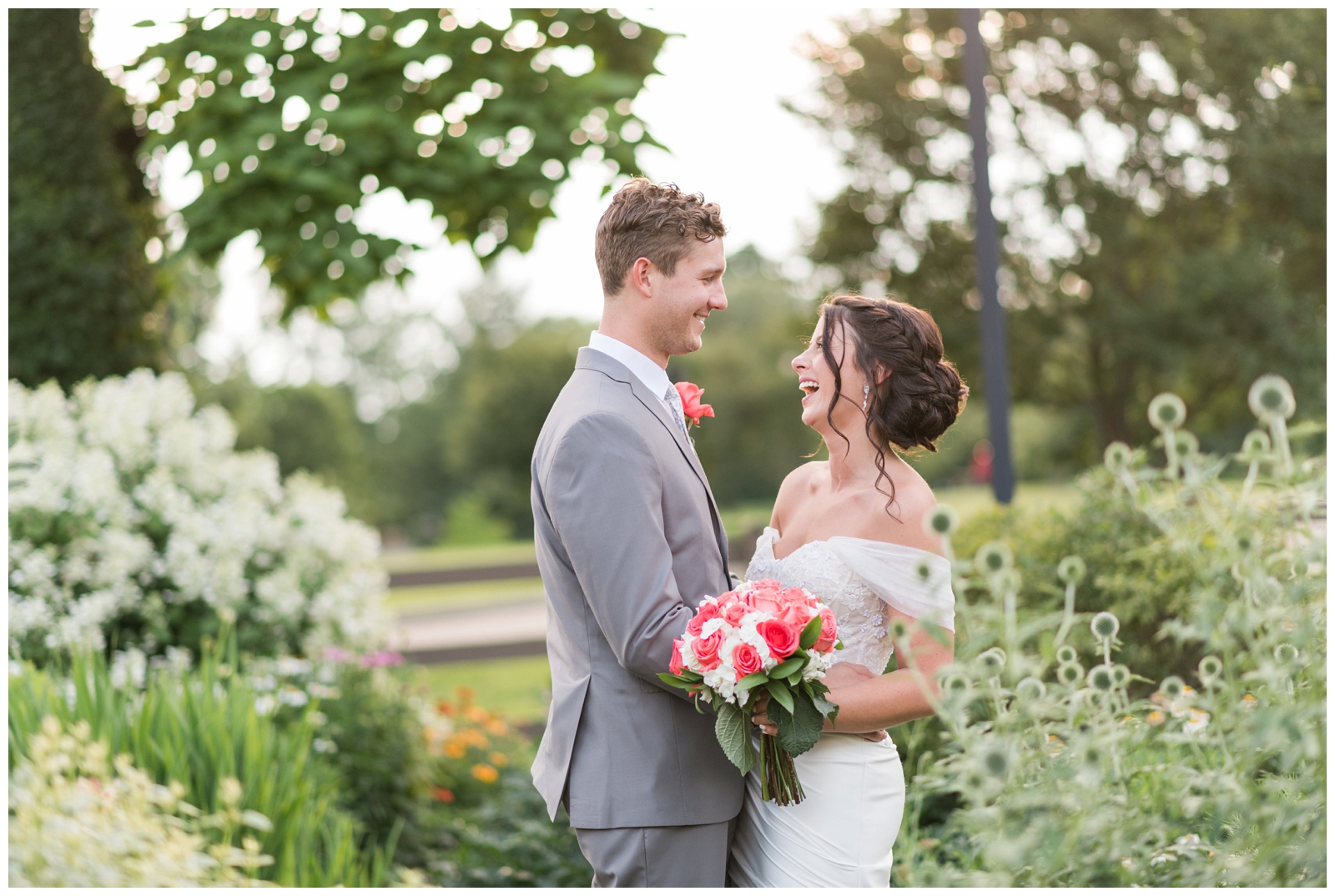 bride and groom laugh and smile at each other in gardens of Franklin Park Conservatory