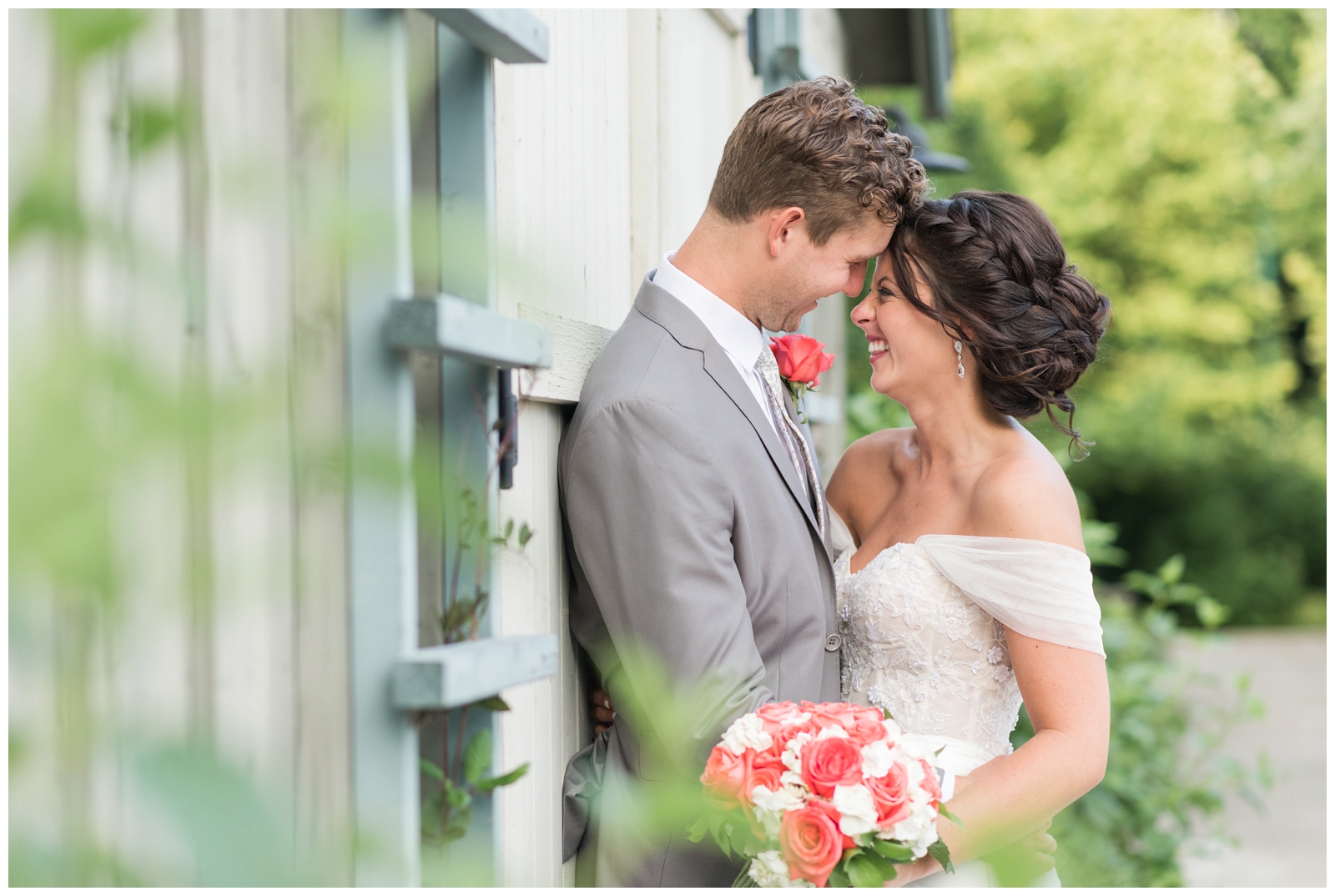 bride and groom grin during portraits along The Wells Barn with OH wedding photographer