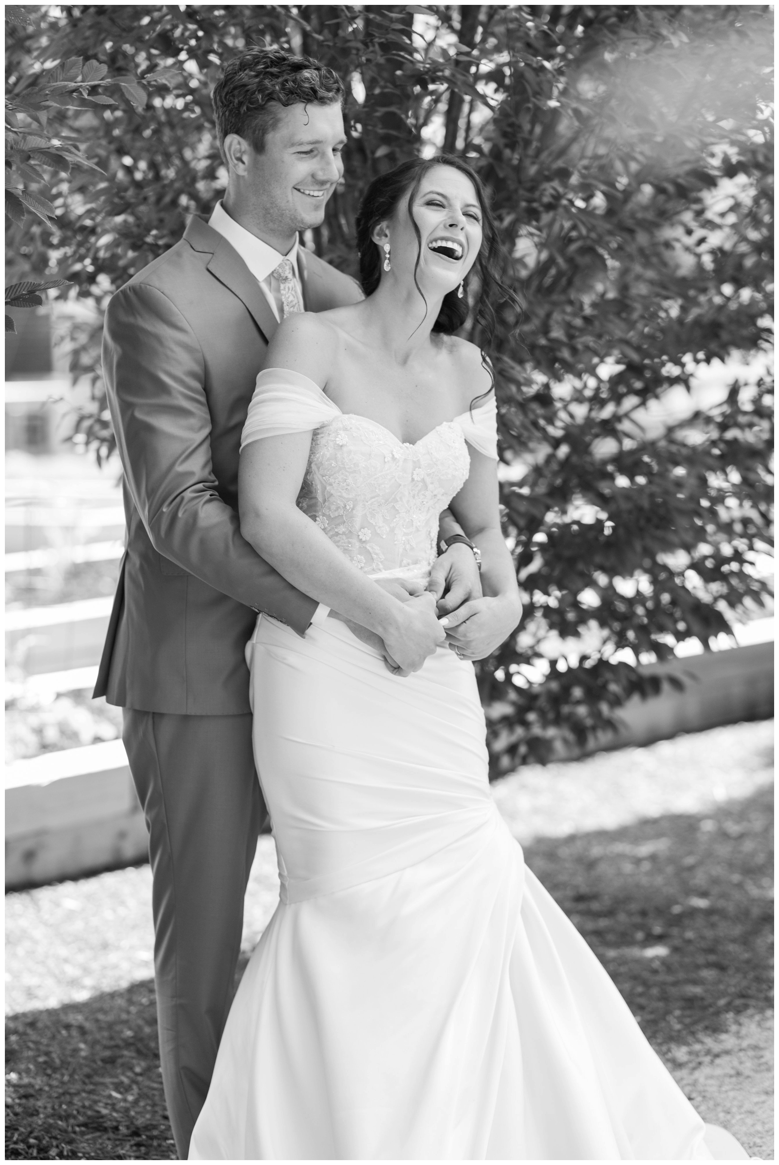 groom makes bride laugh while holding her on Ohio wedding day at The Wells Barn