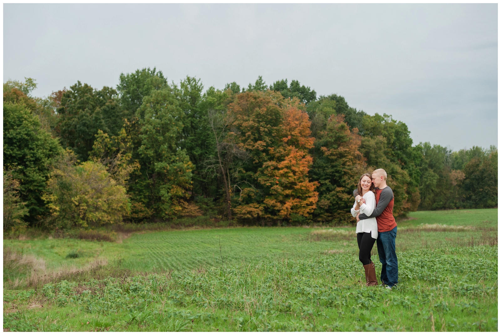 engaged couple hugging in the field during their country engagement session in sunbury ohio 