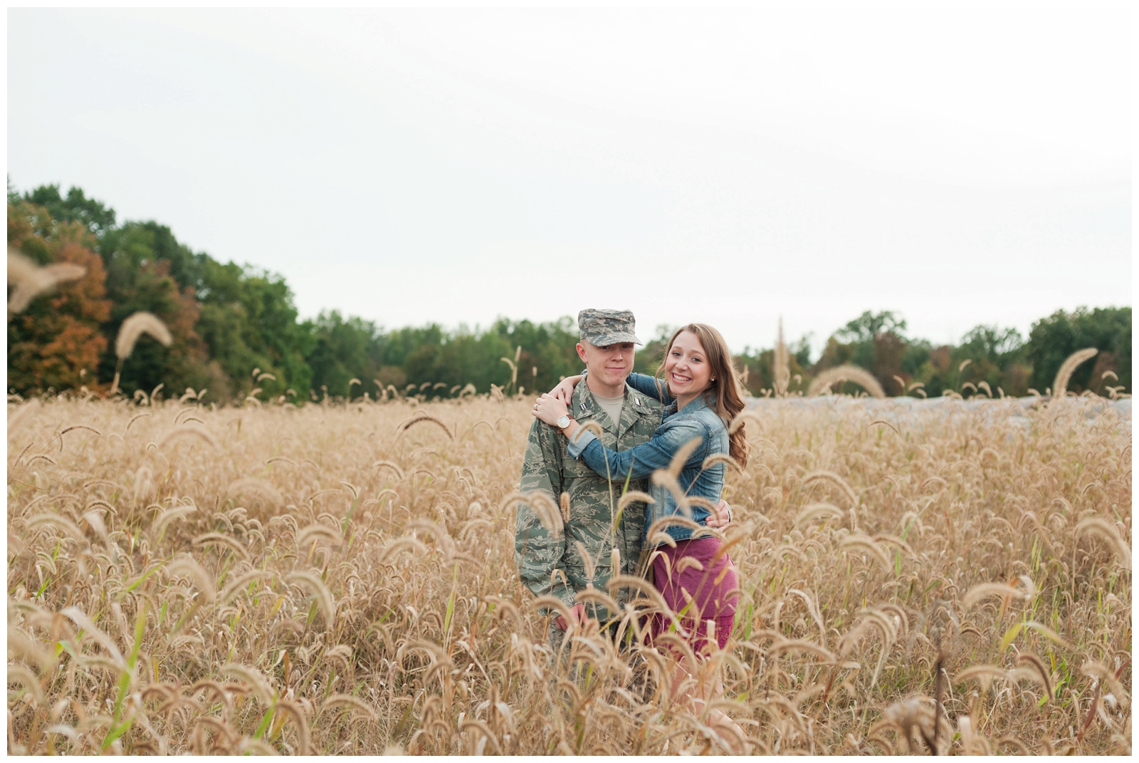 engaged girl hugging her fiancé during engagement session in wheat field 