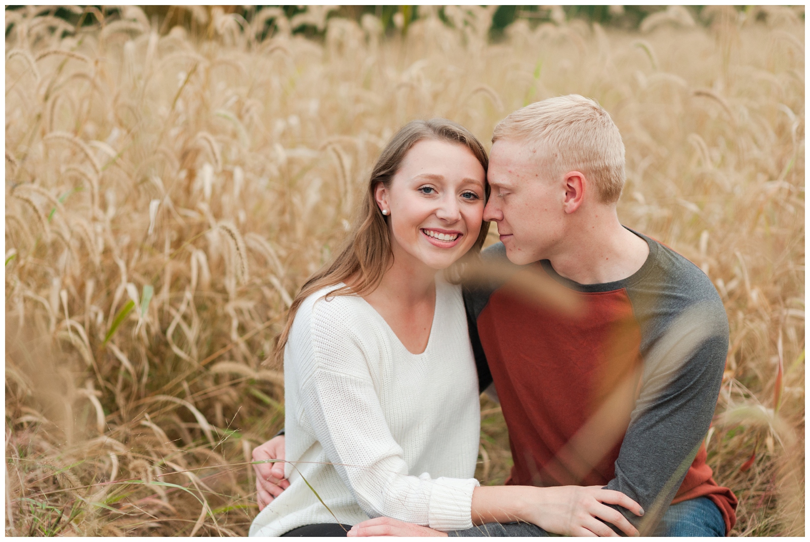 engaged couple romantically snuggled together in wheat field Country Engagement Session Sunbury Ohio