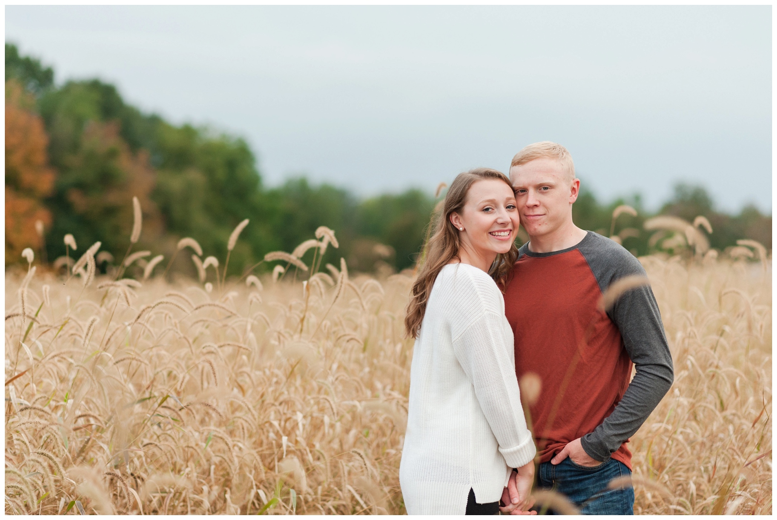 engaged couple looking happily at camera during Country Engagement Session Sunbury Ohio