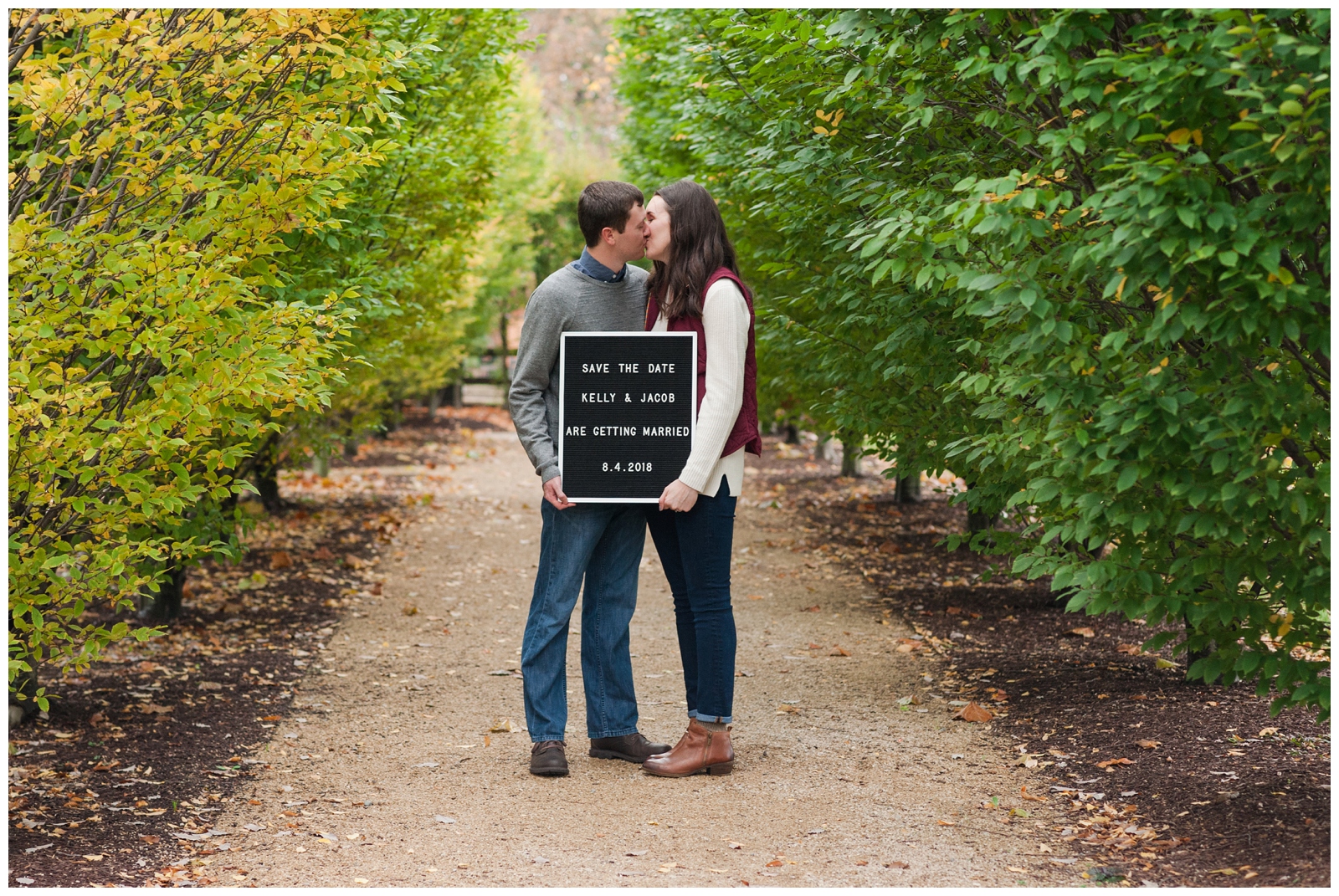 save the date engagement photos with girl and boy kissing in the fall time at the wells barn in columbus ohio 