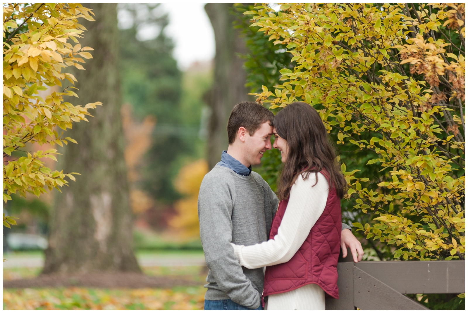 girl and boy looking at each other during their Beautiful fall Franklin Park Conservatory Engagement Session