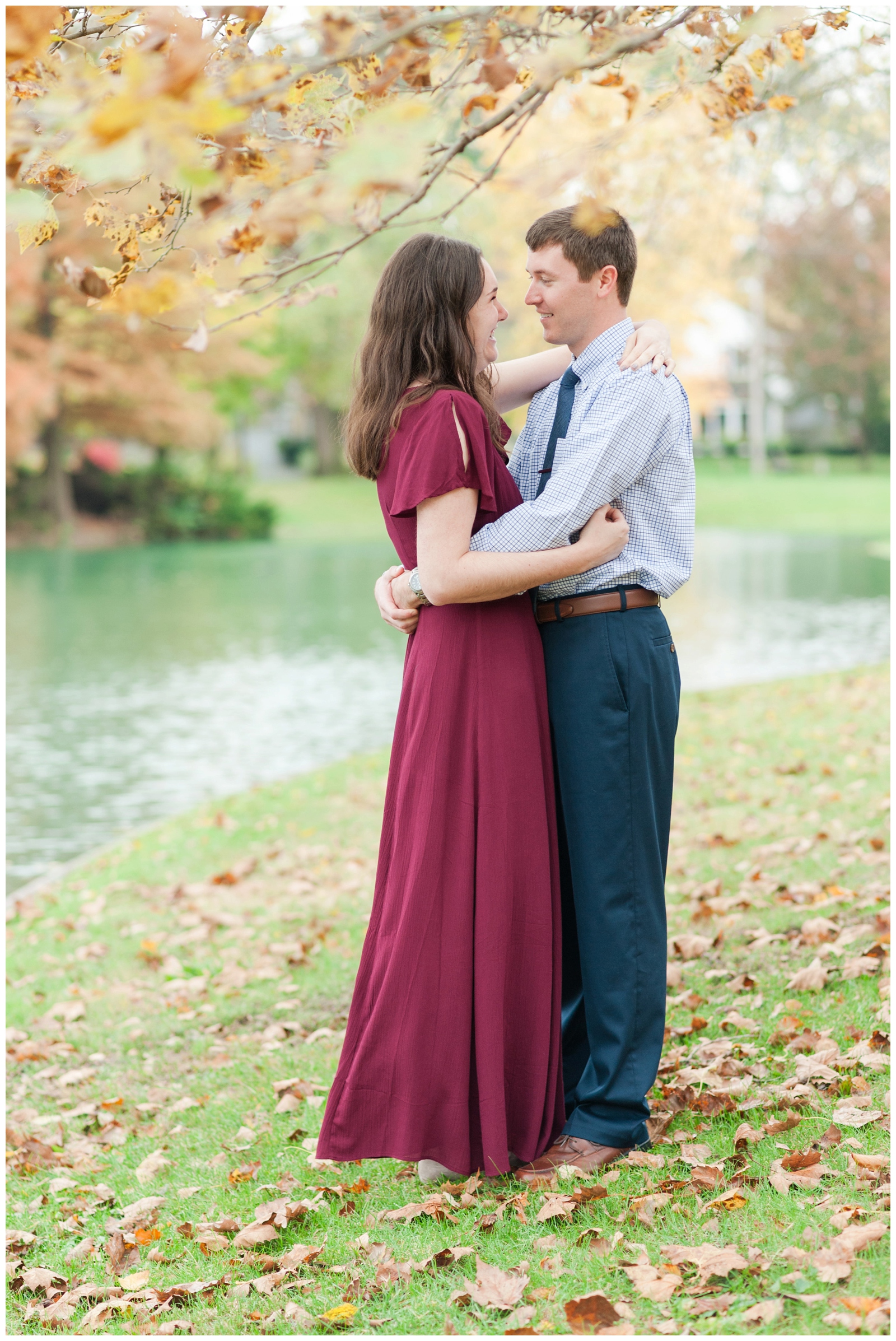 girl and boy happily looking into each other's eyes during their fall engagement session at franklin park conservatory 
