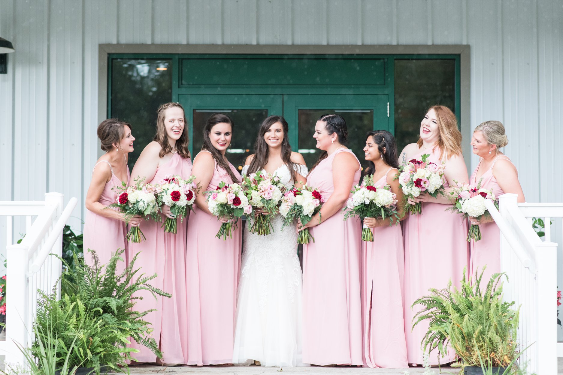 bride standing with all of her bridesmaids columbus ohio luxury wedding photographer