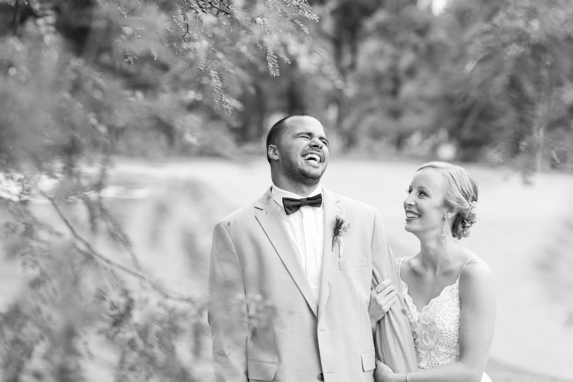 groom laughing and bride looking at groom in black and white at pinnacle golf club in grove city ohio