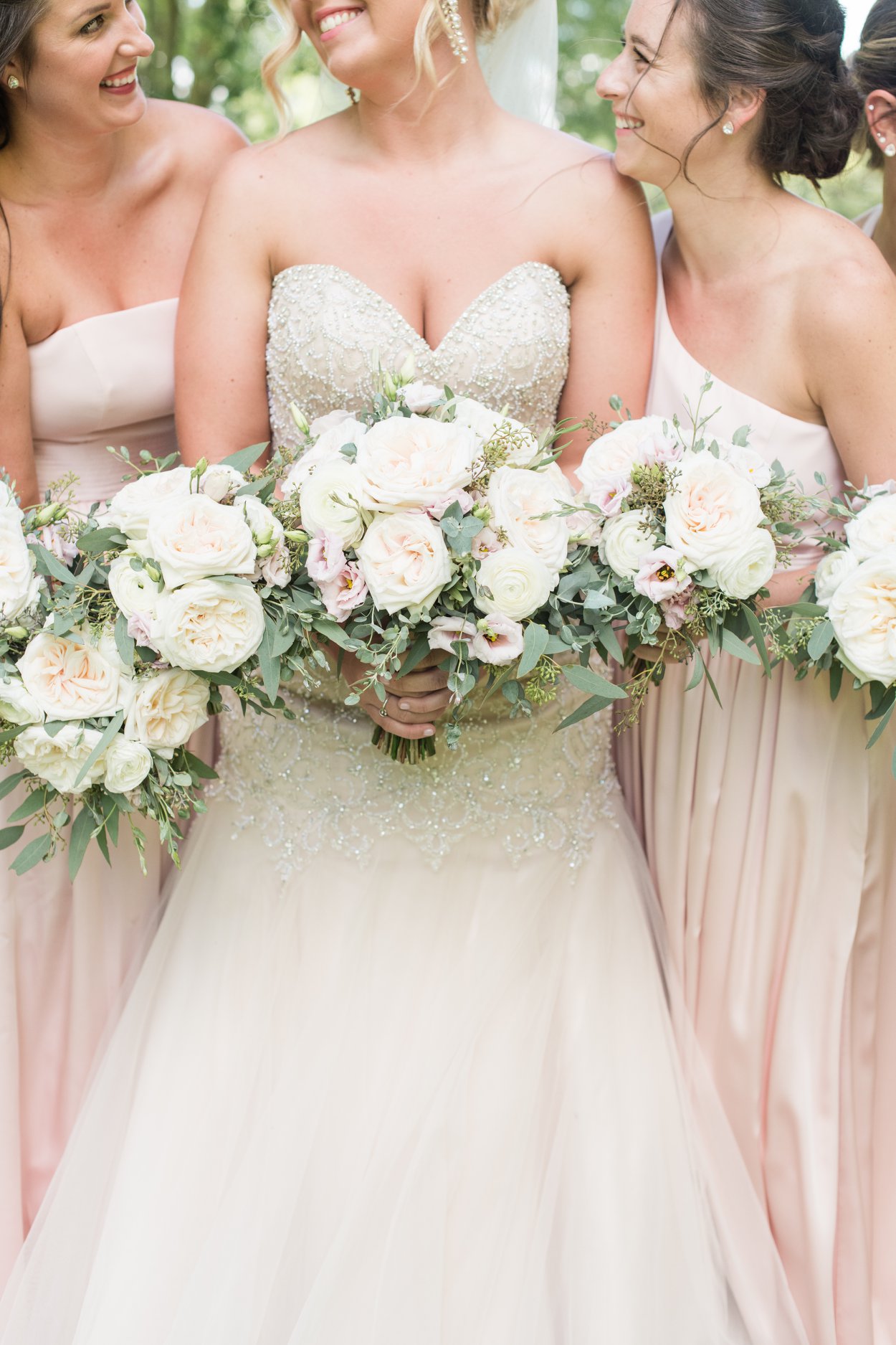 bride and bridesmaids on wedding day with their wedding flowers in focus columbus ohio luxury wedding photographer