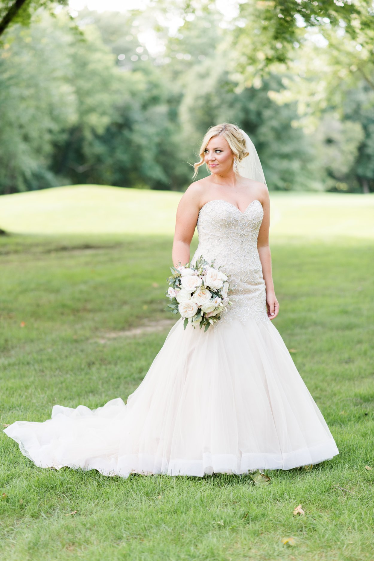 bride smiling off her shoulder outsides at brookside golf and country club wedding columbus ohio luxury wedding photographer
