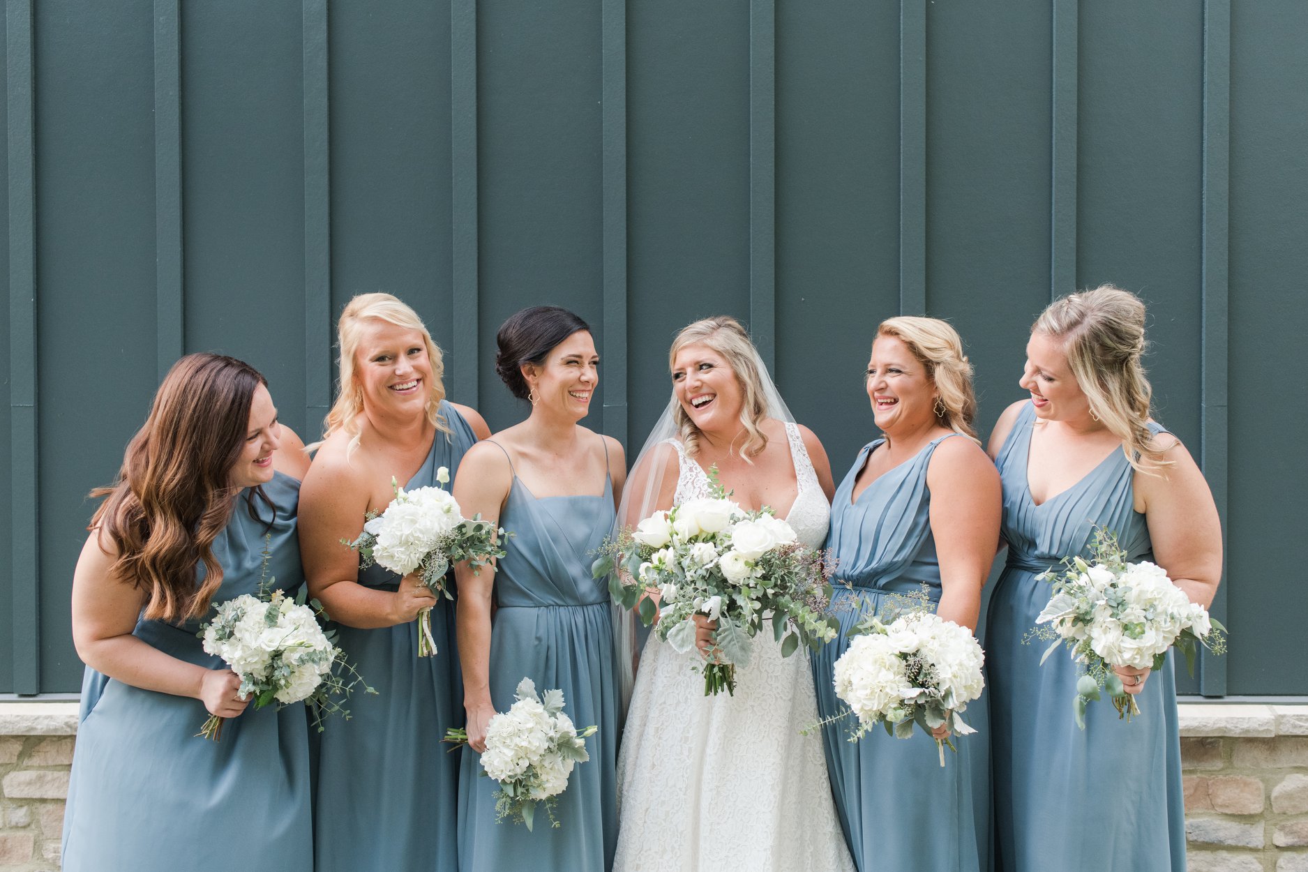 bride laughing with bridesmaids at the estate at new albany wedding columbus ohio luxury wedding photographer