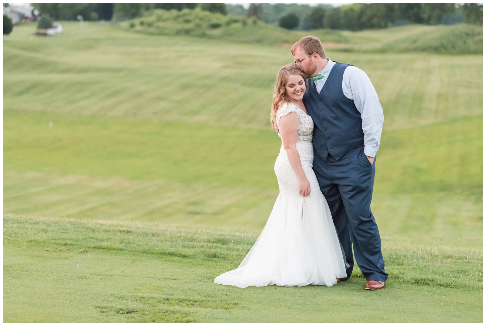 newly married couple pose during Ohio wedding day on green at EagleSticks Golf Club