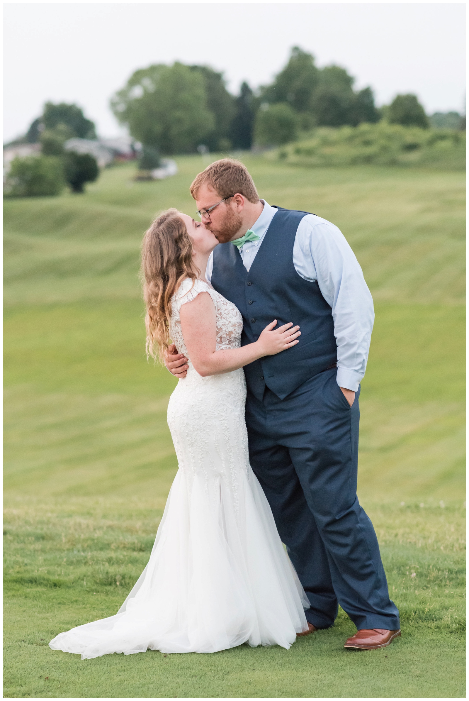 bride and groom kiss during romantic summer wedding portraits at EagleSticks Golf Club