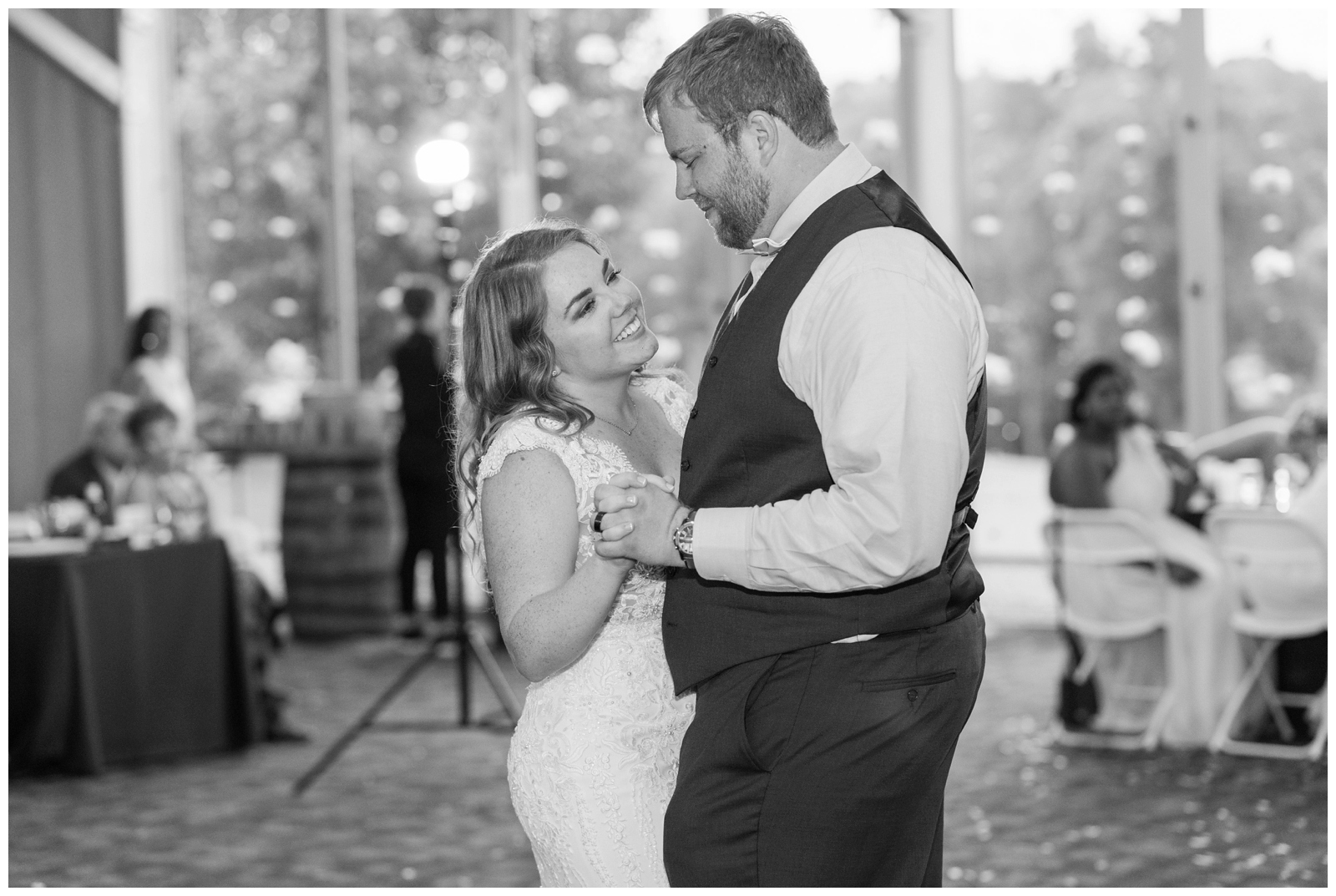 bride and groom have first dance during tented wedding reception in Ohio