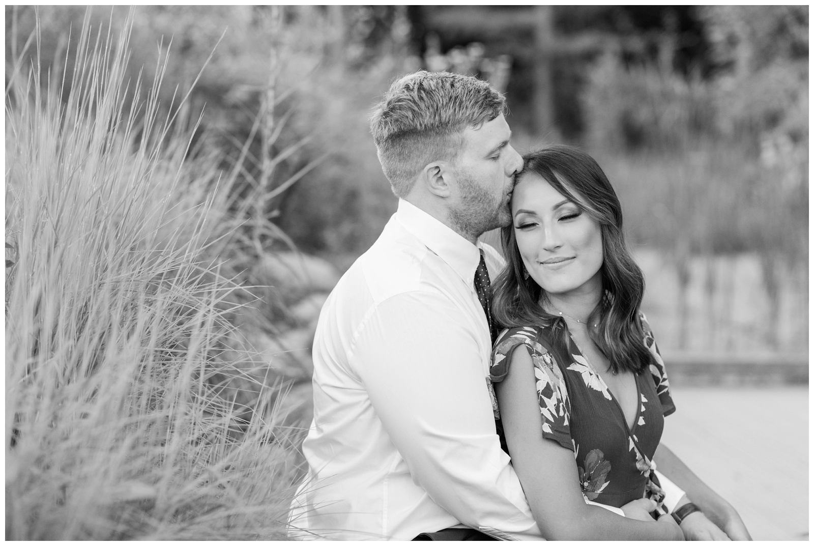 black and white image of man kissing woman on forehead during engagement session at inniswood metro garden 