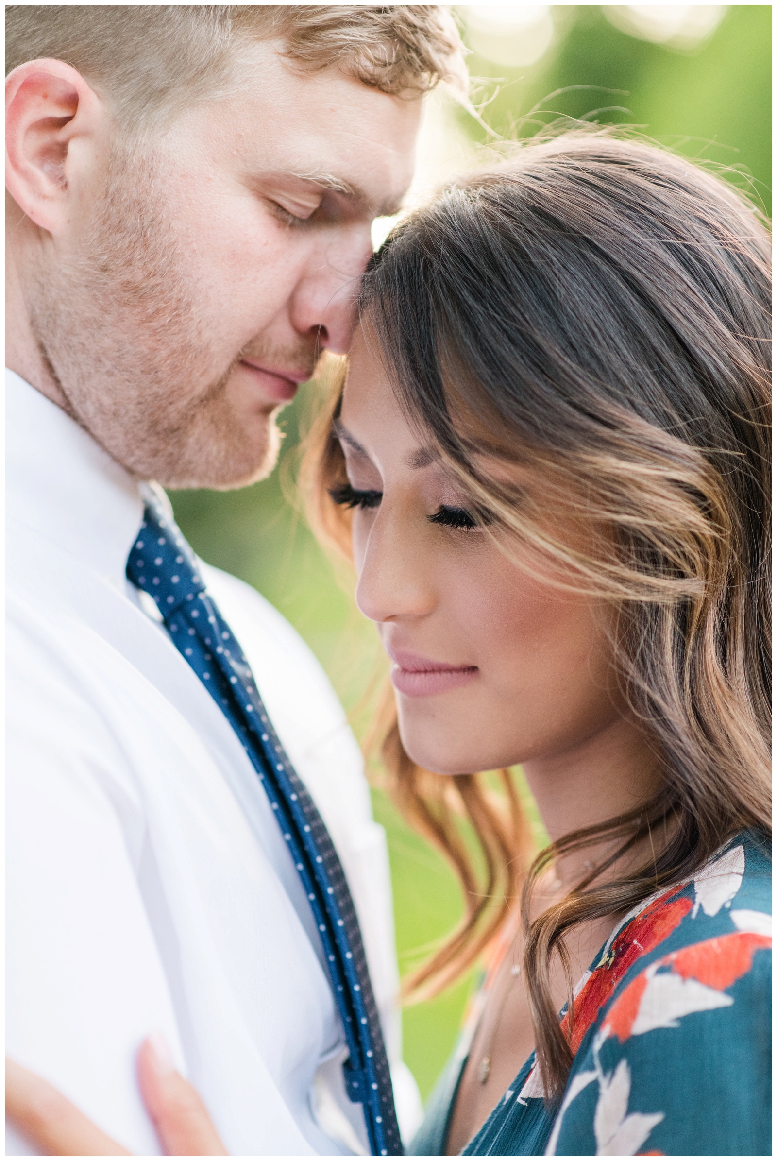 man and woman in tender embrace during their fun and romantic engagement session at inniswood metro garden in westerville ohio pipers photography 