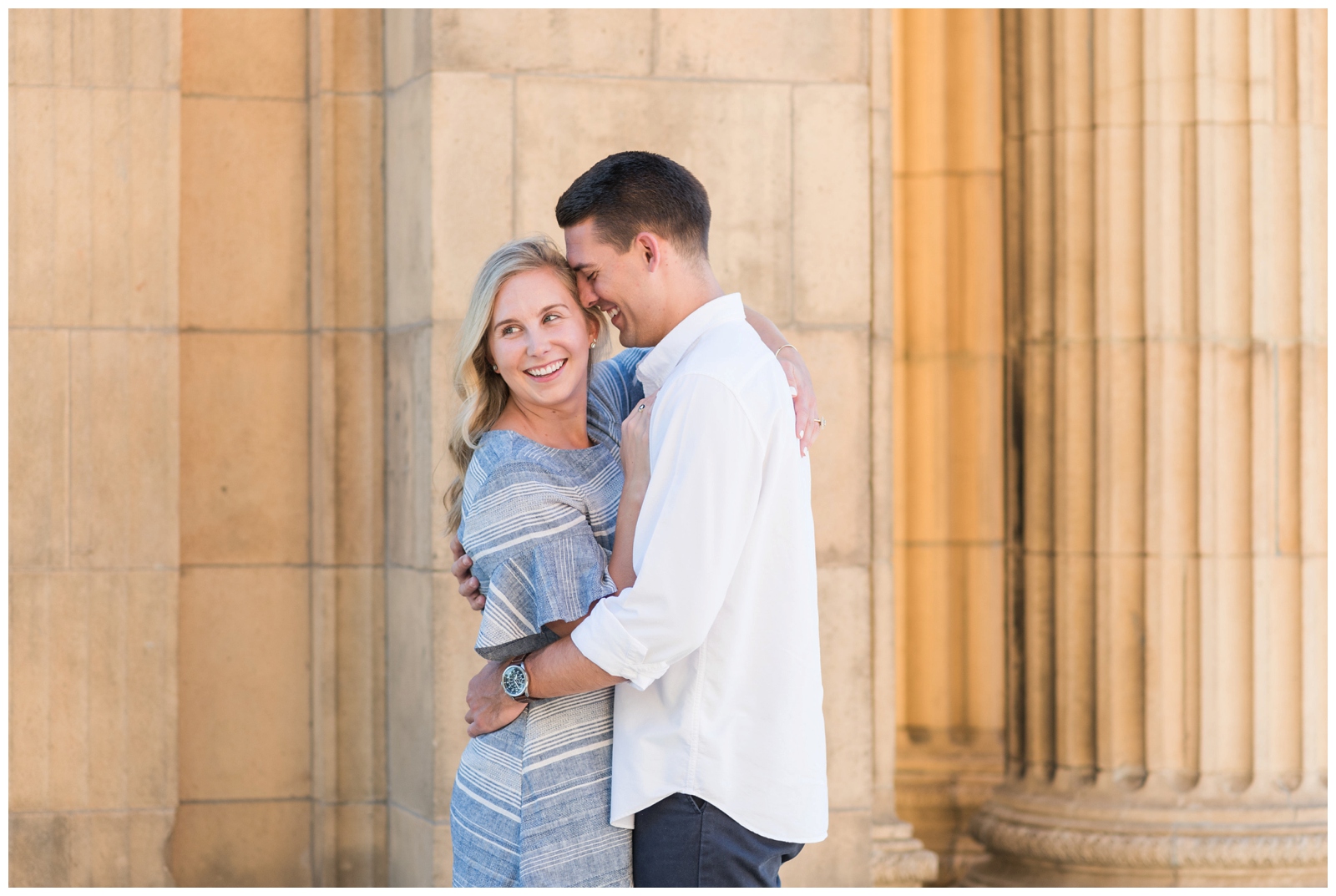 bride in blue gown poses at Union Station with groom during engagement session