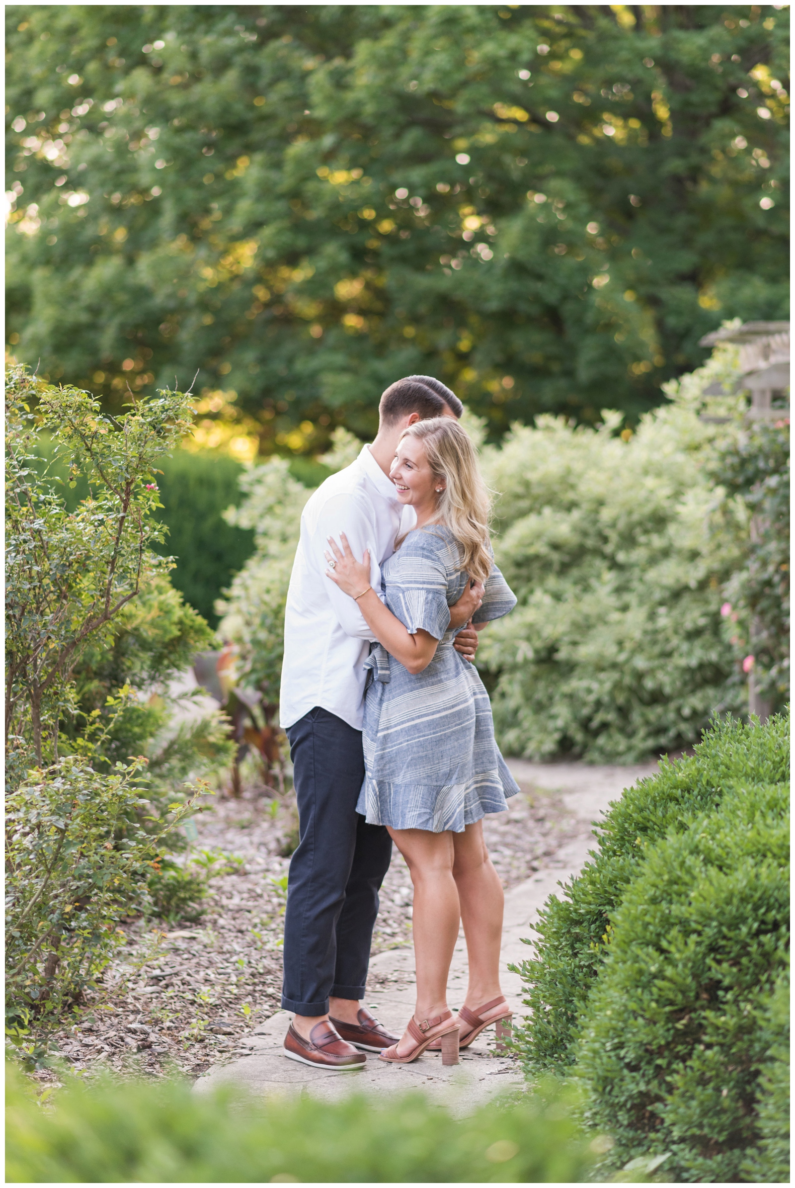 Bride and groom hug in Park of Roses during Ohio engagement session