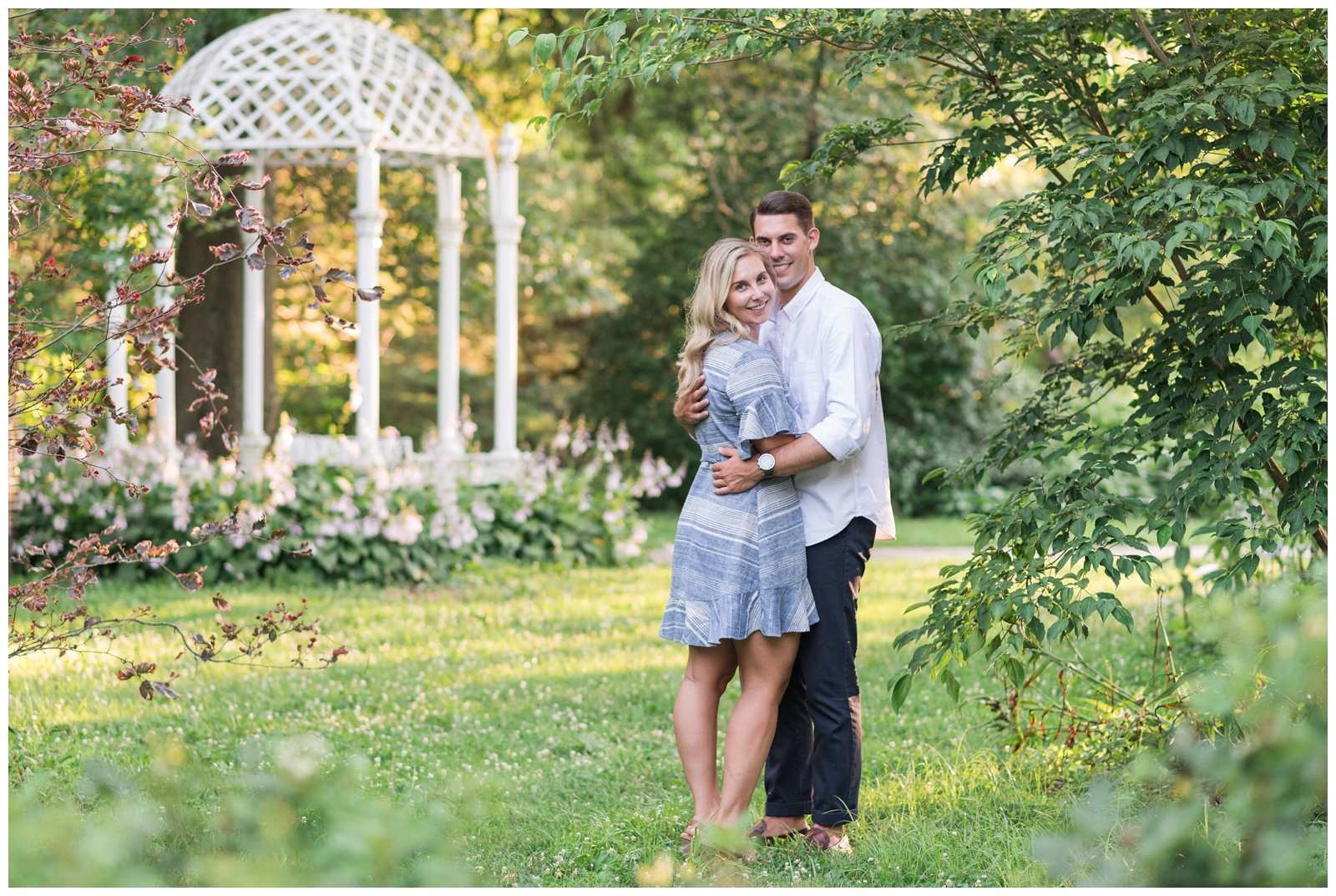 bride and groom pose by gazebo at Park of Roses for engagement session