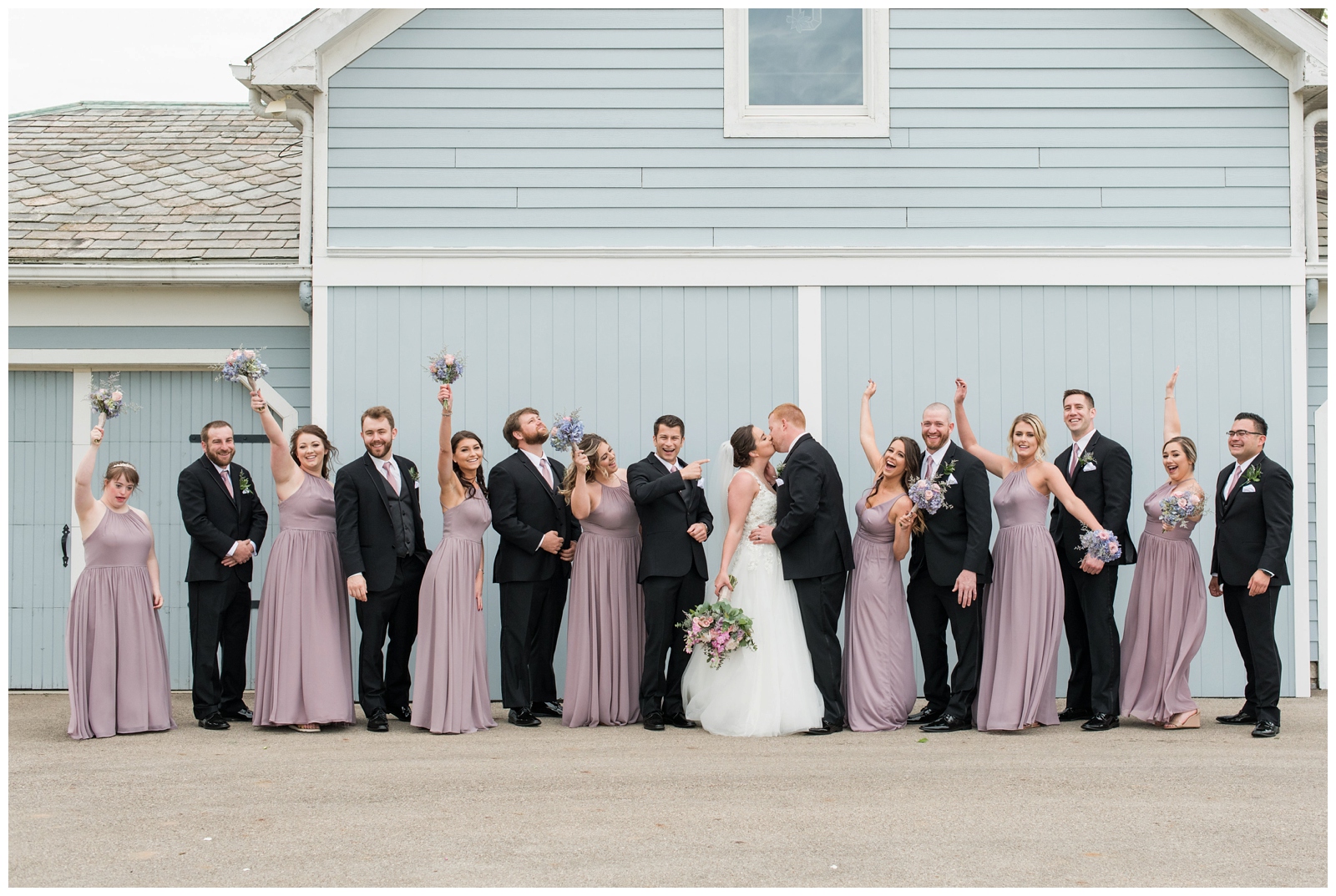 bridal party celebrates bride and groom during portraits at Pretty Prairie Farms
