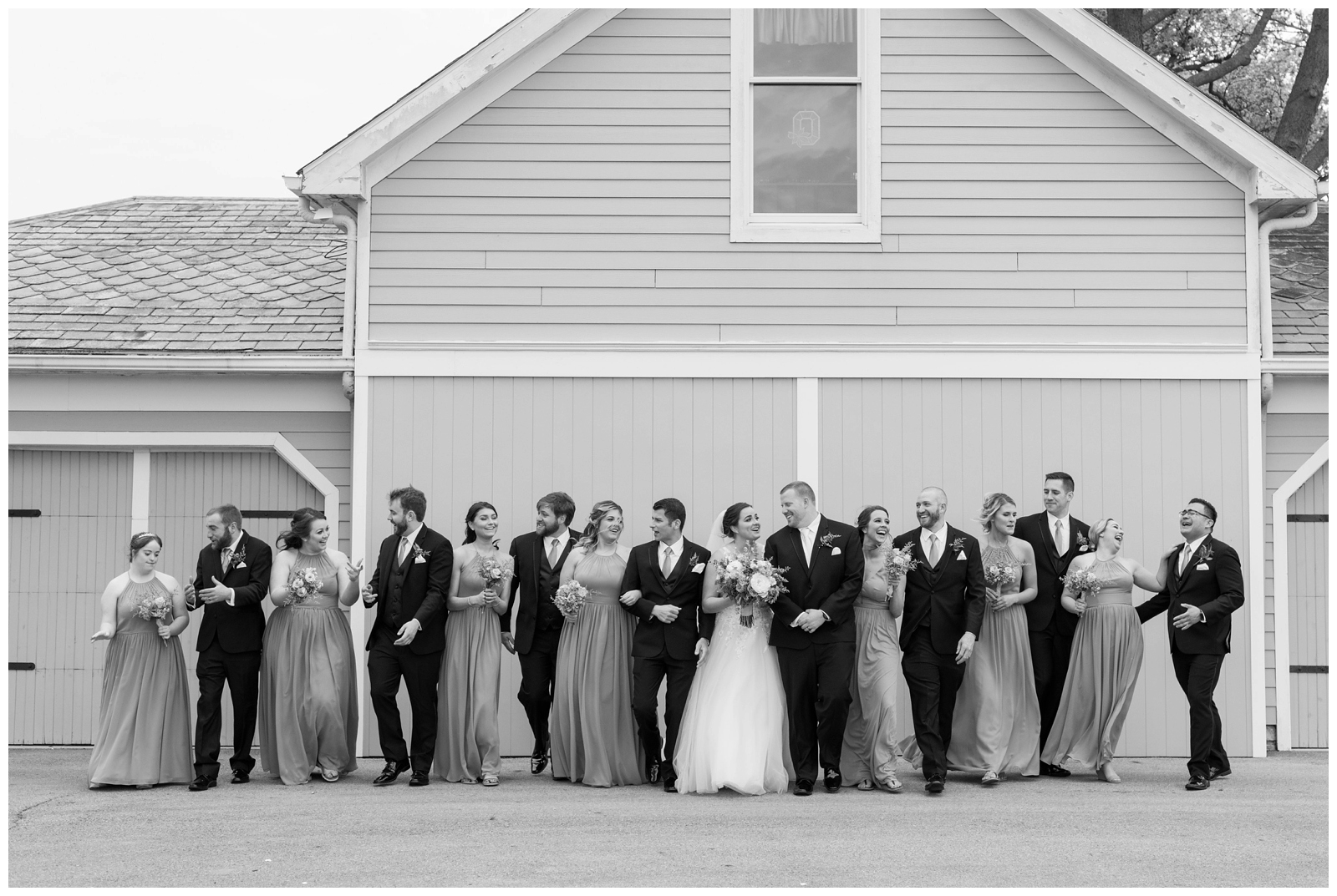 black and white relaxed bridal party portraits with bride and groom