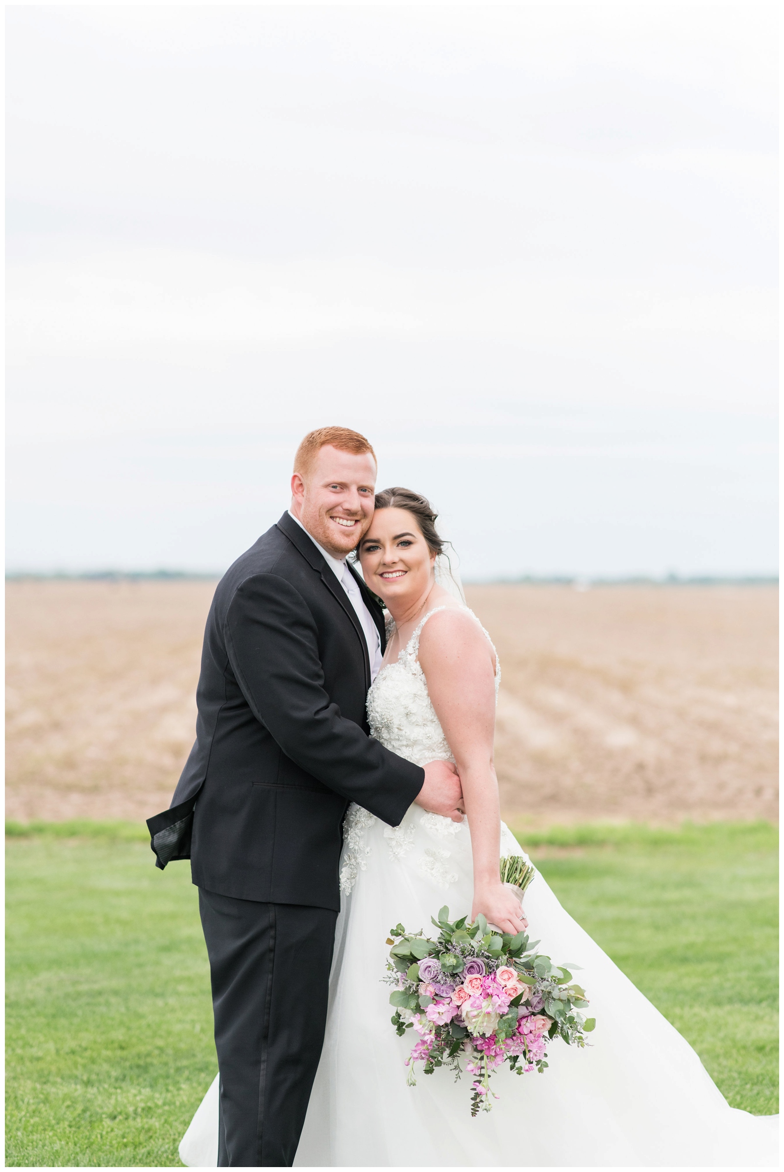 Bride and Groom smile during Ohio wedding portraits on farm