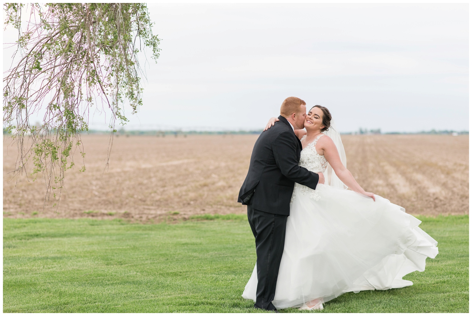 bride twirls dress while dancing with groom on Pretty Prairie Farms