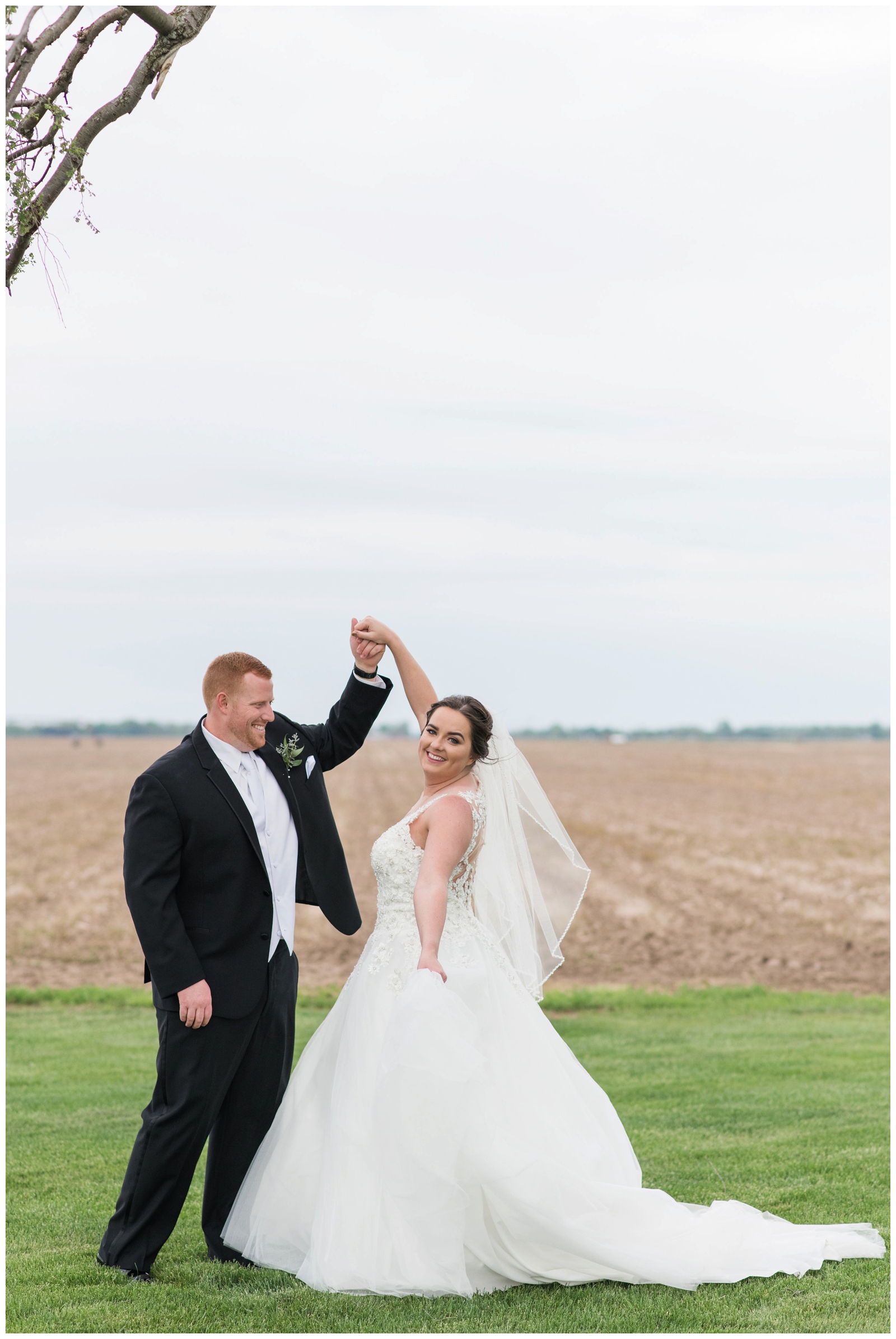 bride and groom dance during wedding portraits at Pretty Prairie Farms