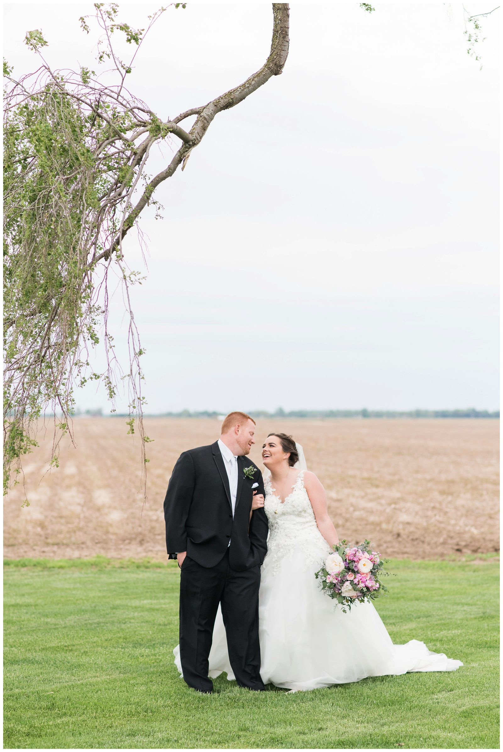 bride looks at new husband during portraits by willow tree