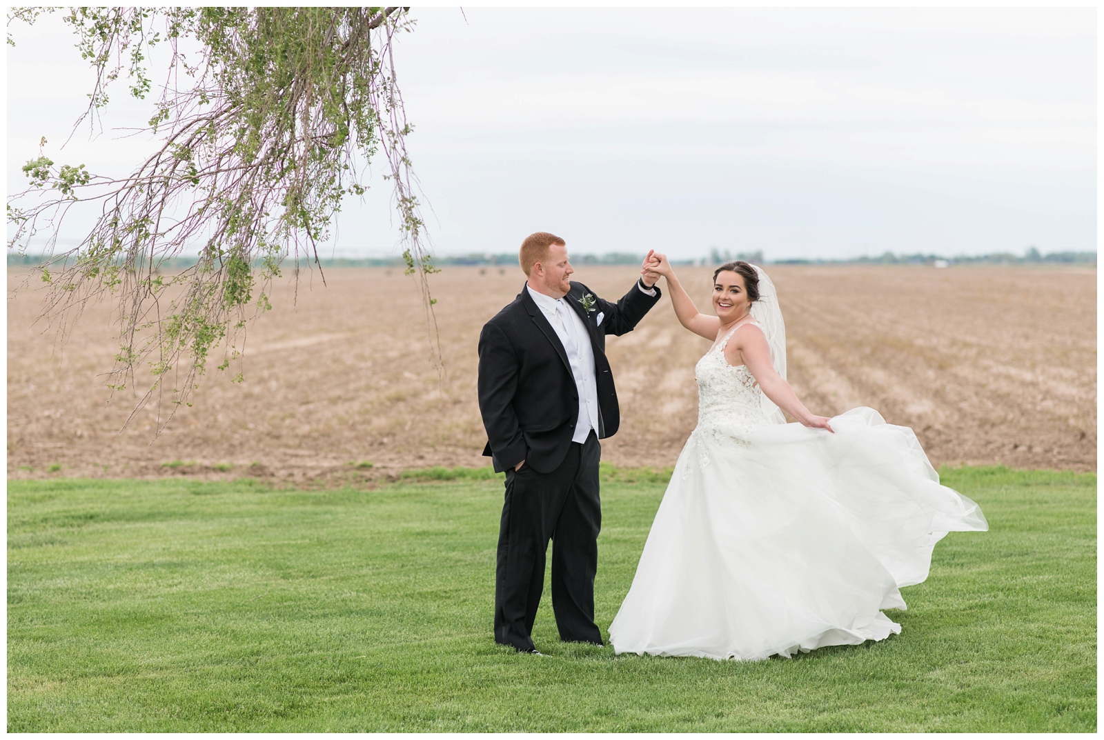 groom twirls bride during portraits on Ohio wedding day