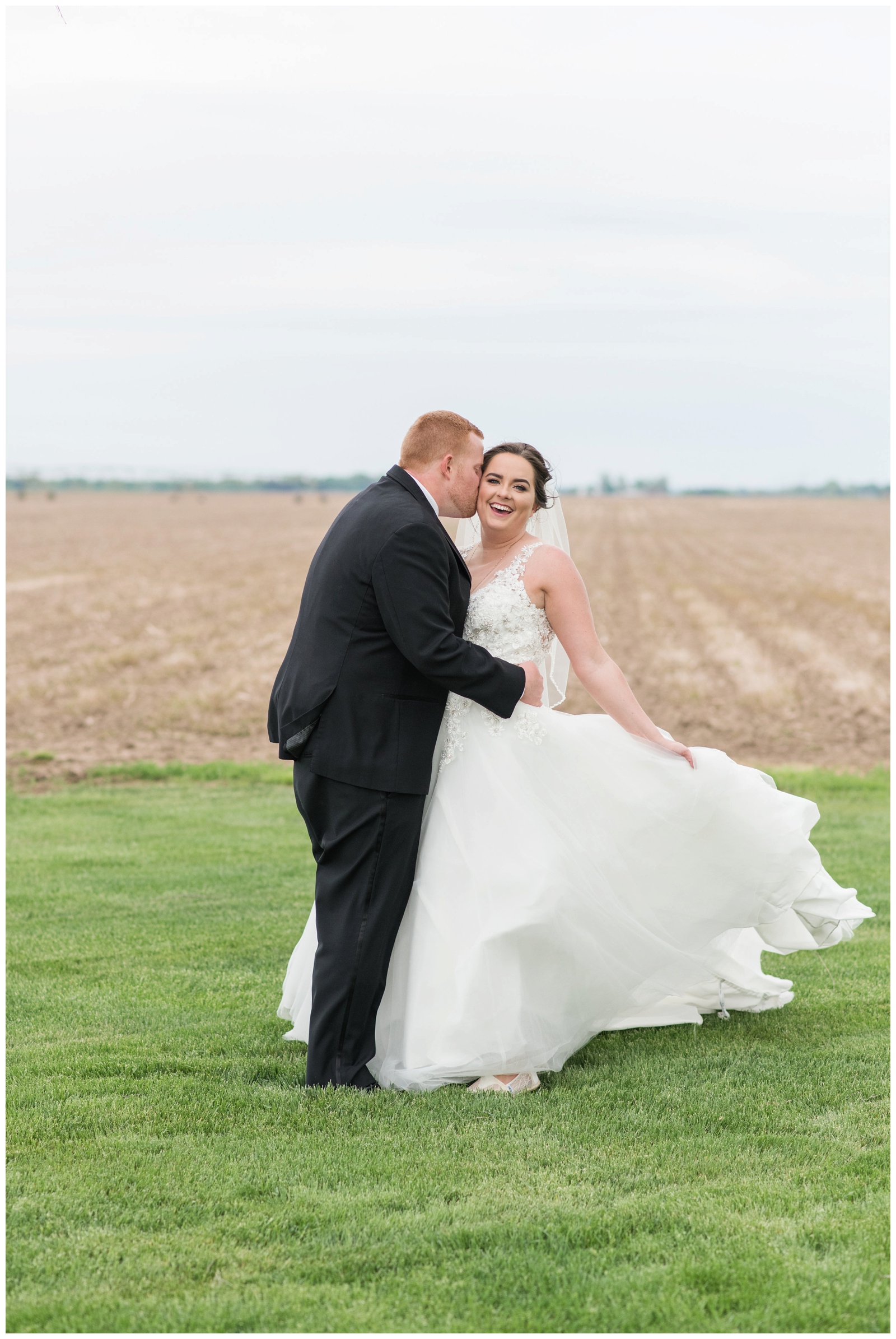 bride and groom dance during wedding portraits at Urbana OH wedding venue Pretty Prairie Farms