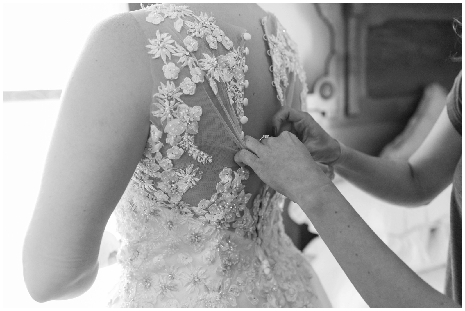 bridesmaid helping bride button lace Madison James wedding gown details photographed by Pipers Photography