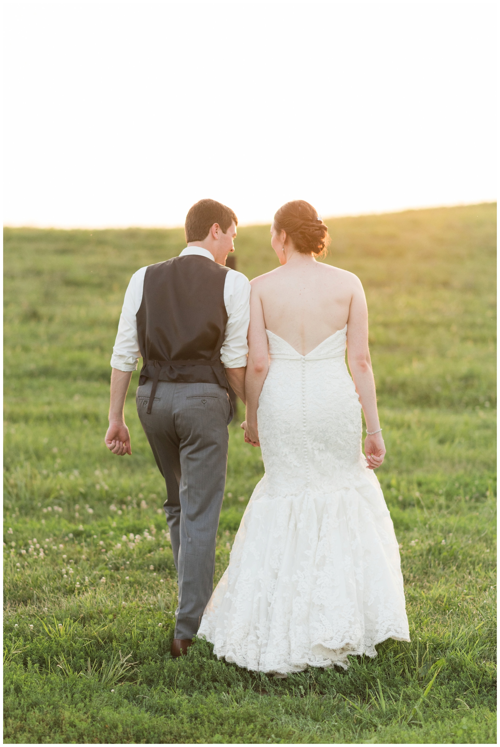 bride and groom walking into a field at sunset on their wedding day at harvest adventures in bremen ohio