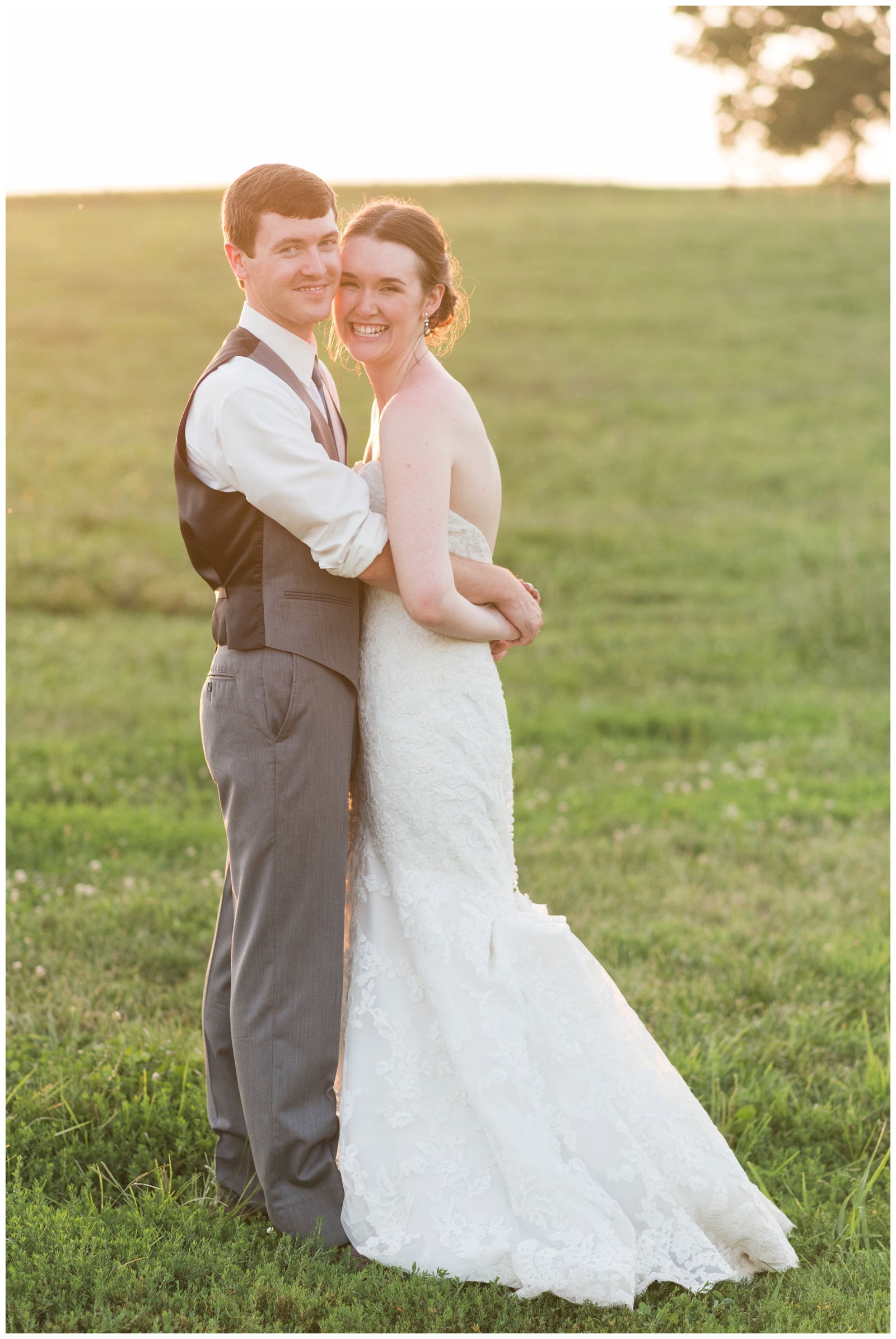 Bride and groom looking into camera smiling on their wedding day at sunset at harvest adventures in bremen ohio