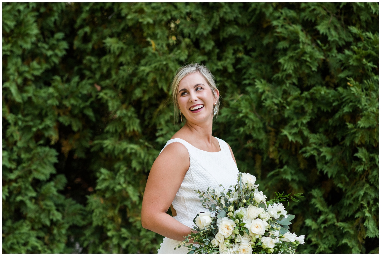 elegant bridal portrait against all green trees with all-white bouquet by Pipers Photography